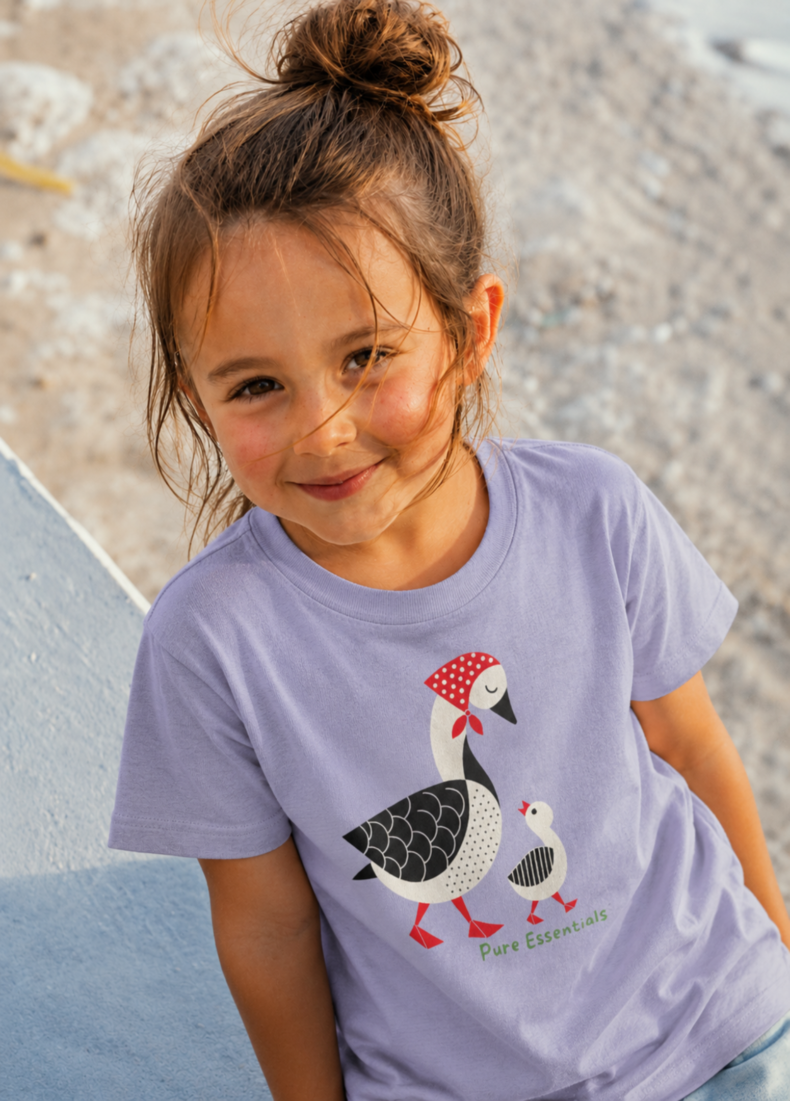 Child wearing a purple t-shirt with a goose design outdoors