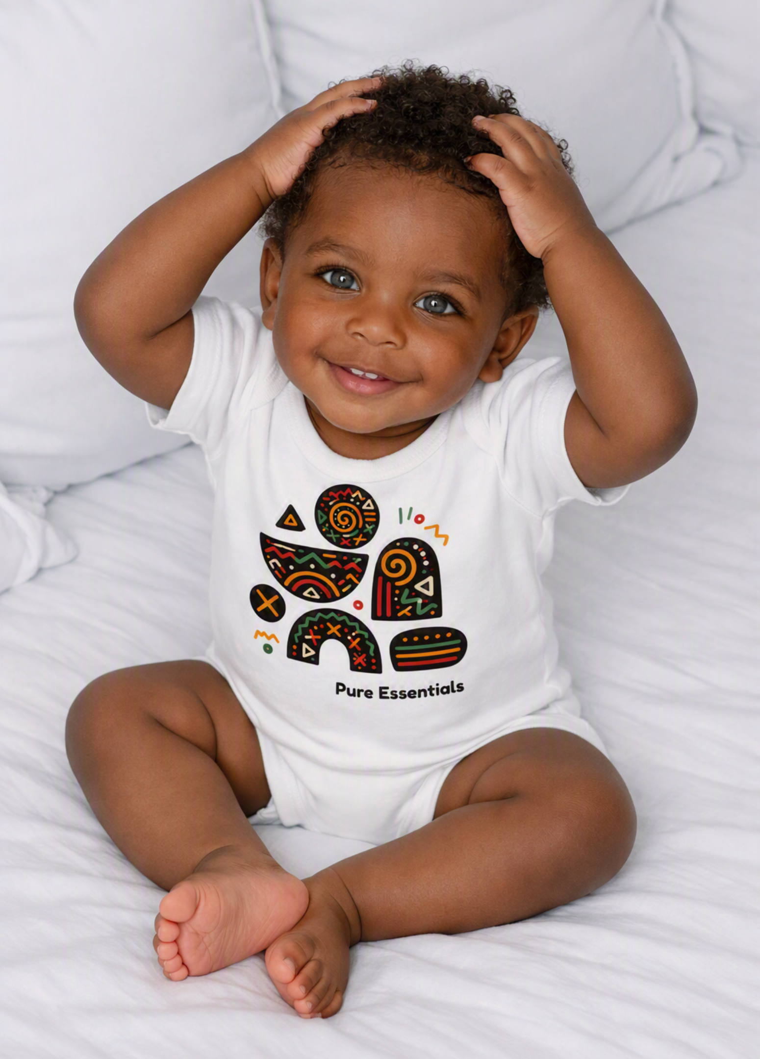 A smiling baby sitting on white bedding wearing a white short-sleeve bodysuit with a colorful geometric graphic and the text 'Pure Essentials'. A 'Made with AI' badge is visible in the top right corner.